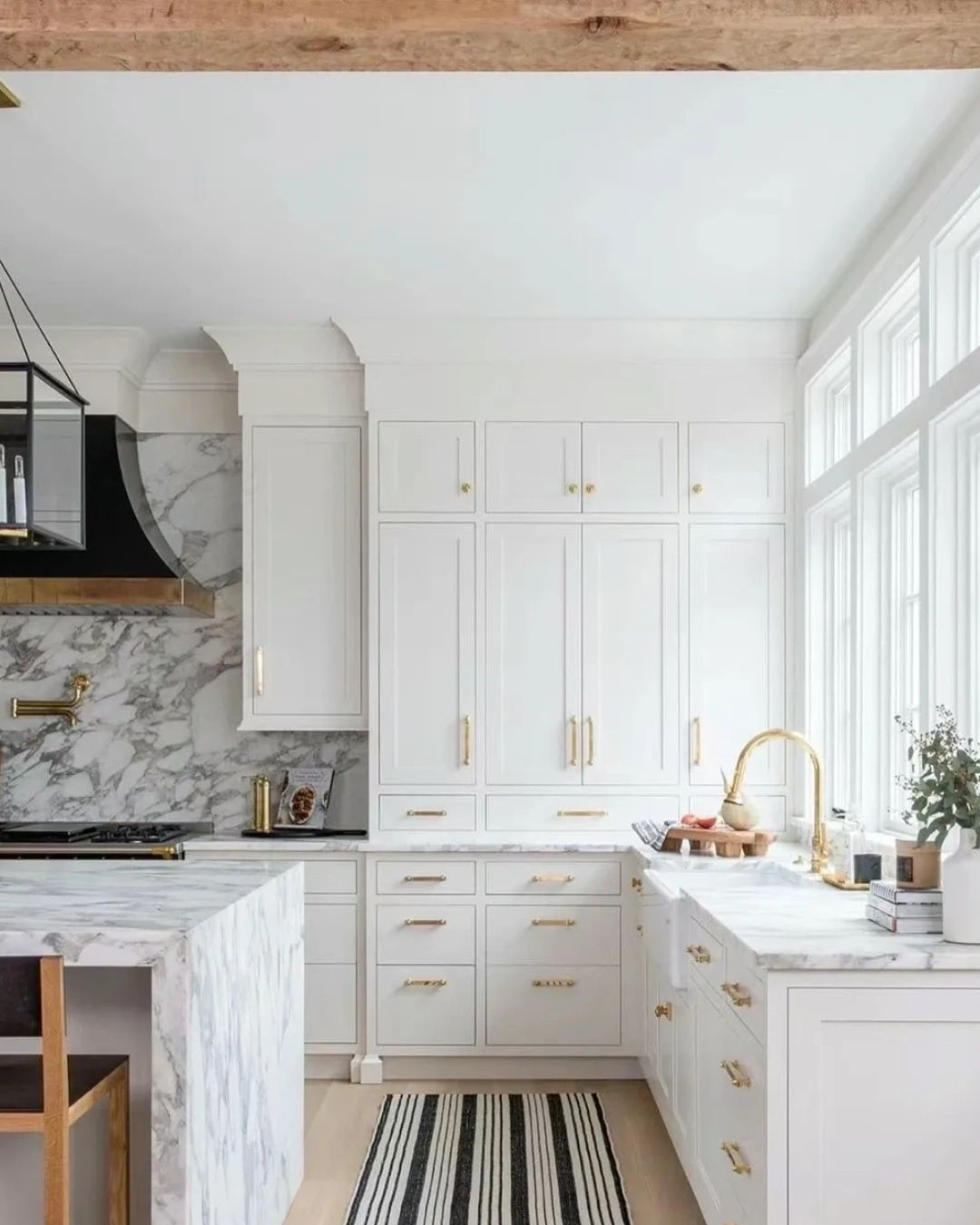 Luxury kitchen with white cabinetry and marble